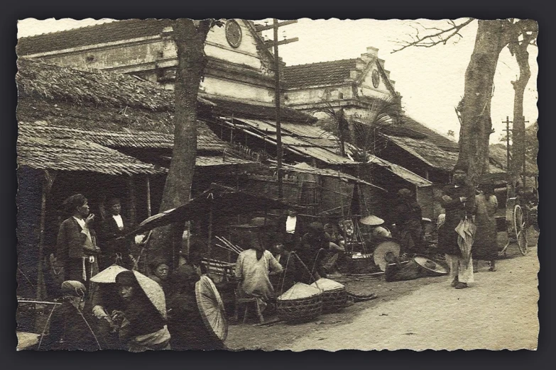 people walk down a street near buildings in an old time po