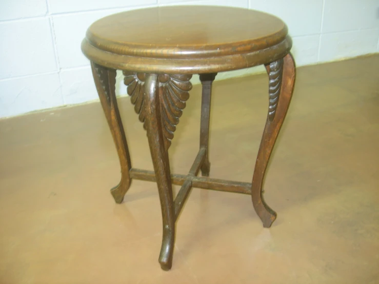 an old wooden table with some nice carvings on it