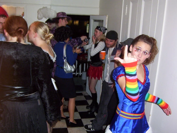 a young person posing for the camera and waving