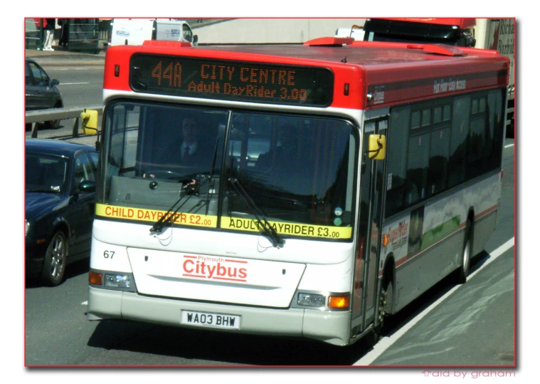 a city bus traveling down the street on the road