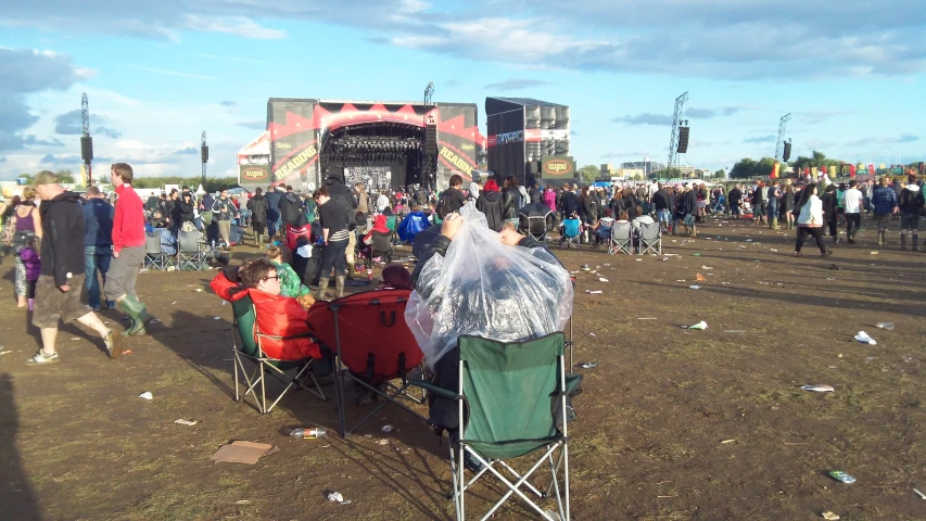 a group of people standing around in a dirt field