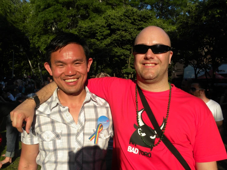 the two men are smiling together at a festival