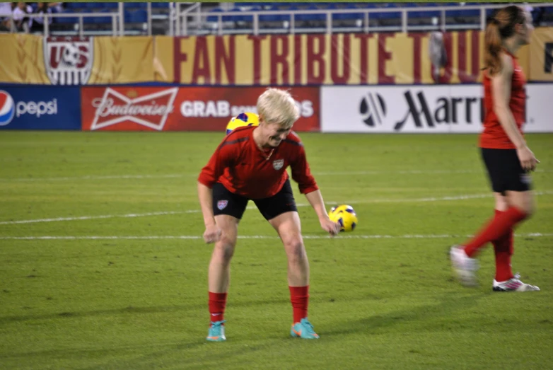 the women are playing soccer on the field