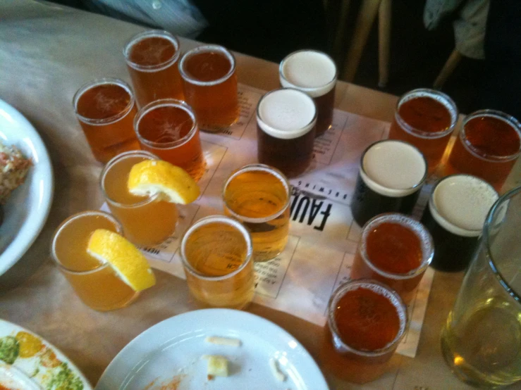 a large variety of drinks sitting on a table