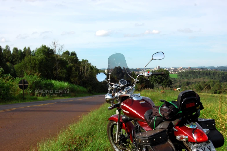 a red and black motorcycle parked on the side of the road