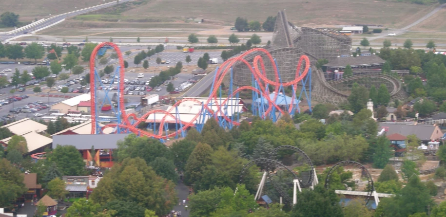 an aerial view of an area that includes several rides, including a ferris wheel