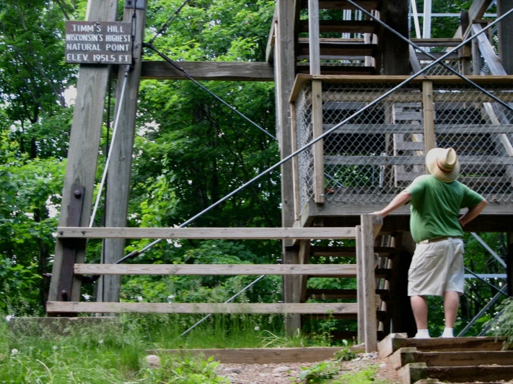 a  stands at the top of stairs with his arms outstretched