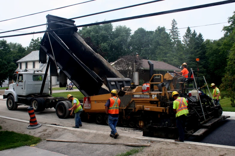 a group of construction workers working on a street