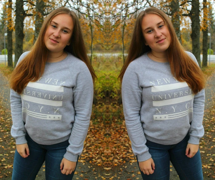 two girls are posing in front of trees