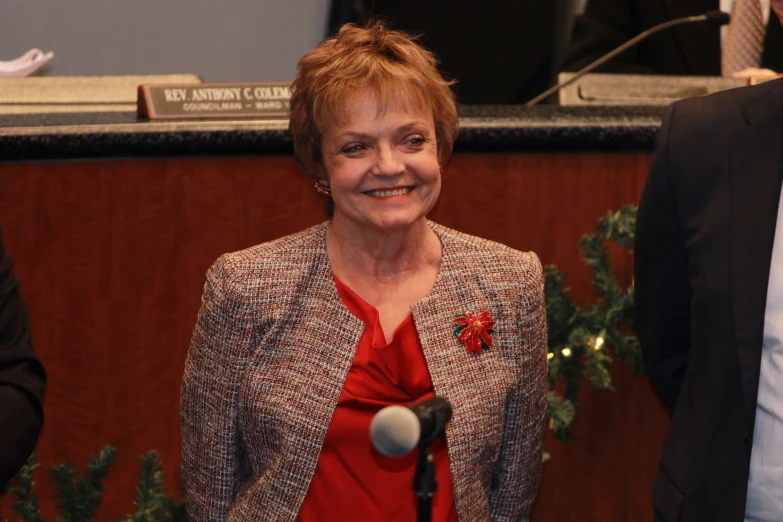 a woman standing in front of a microphone