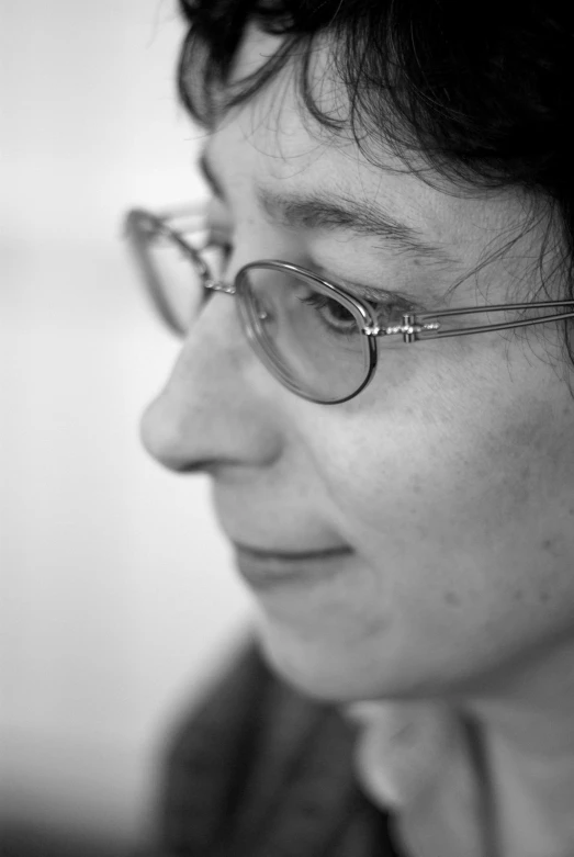 black and white po of woman wearing glasses