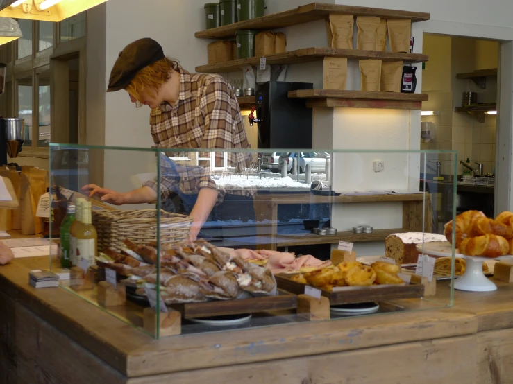 a man cooking inside of a restaurant next to other food