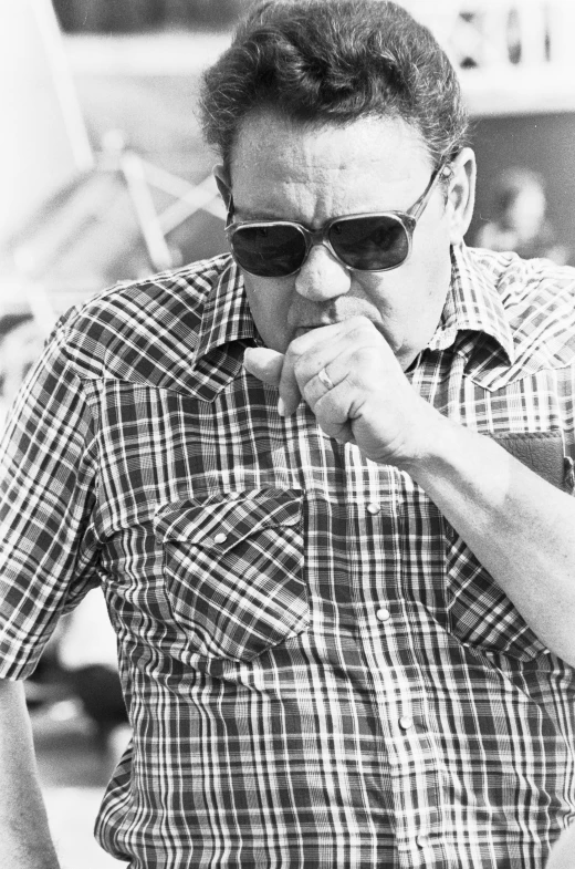 a black and white po of a man in sunglasses