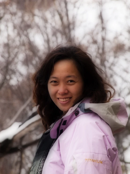 a woman with long brown hair smiling at the camera