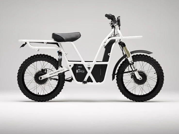 an electric bicycle with wheels parked on a grey surface