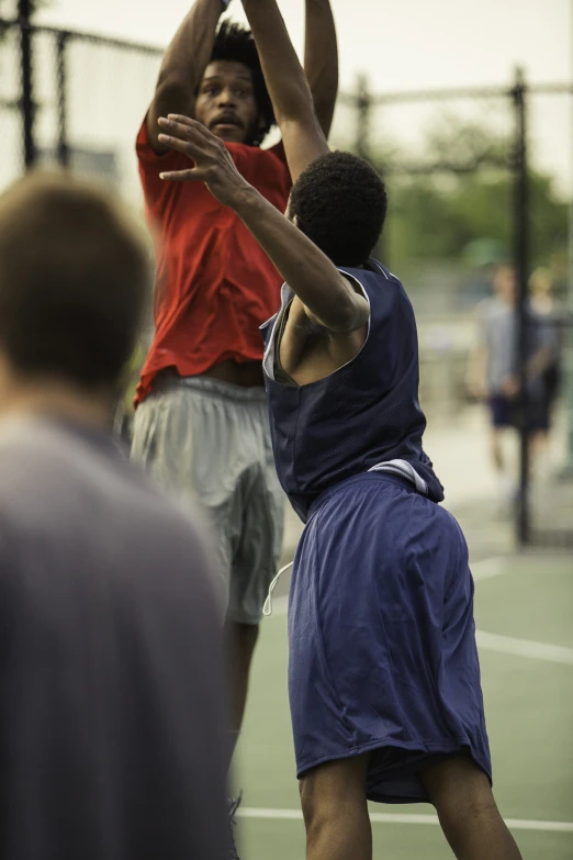 three men playing basketball and holding hands out to the side