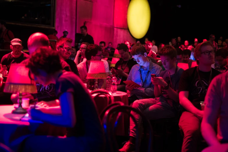 a large group of people in the audience watching soing