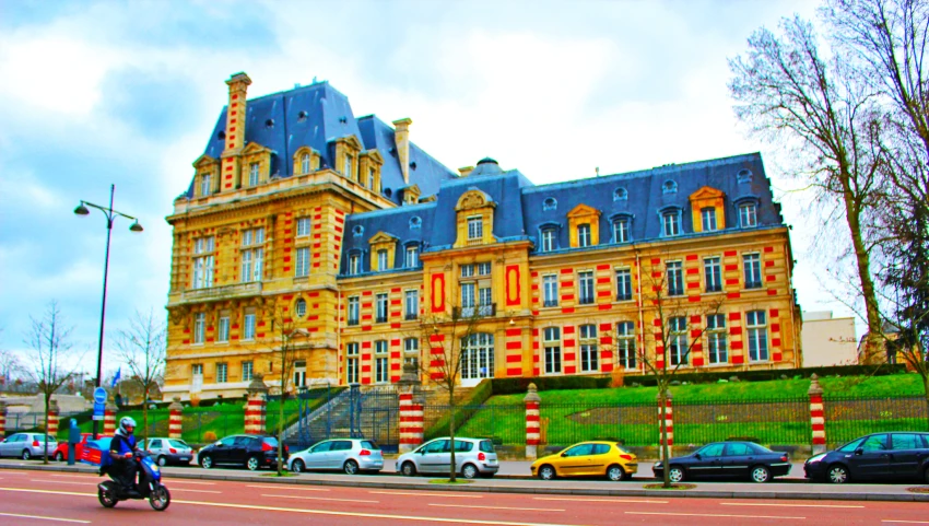 a big building sitting next to a street with a yellow line