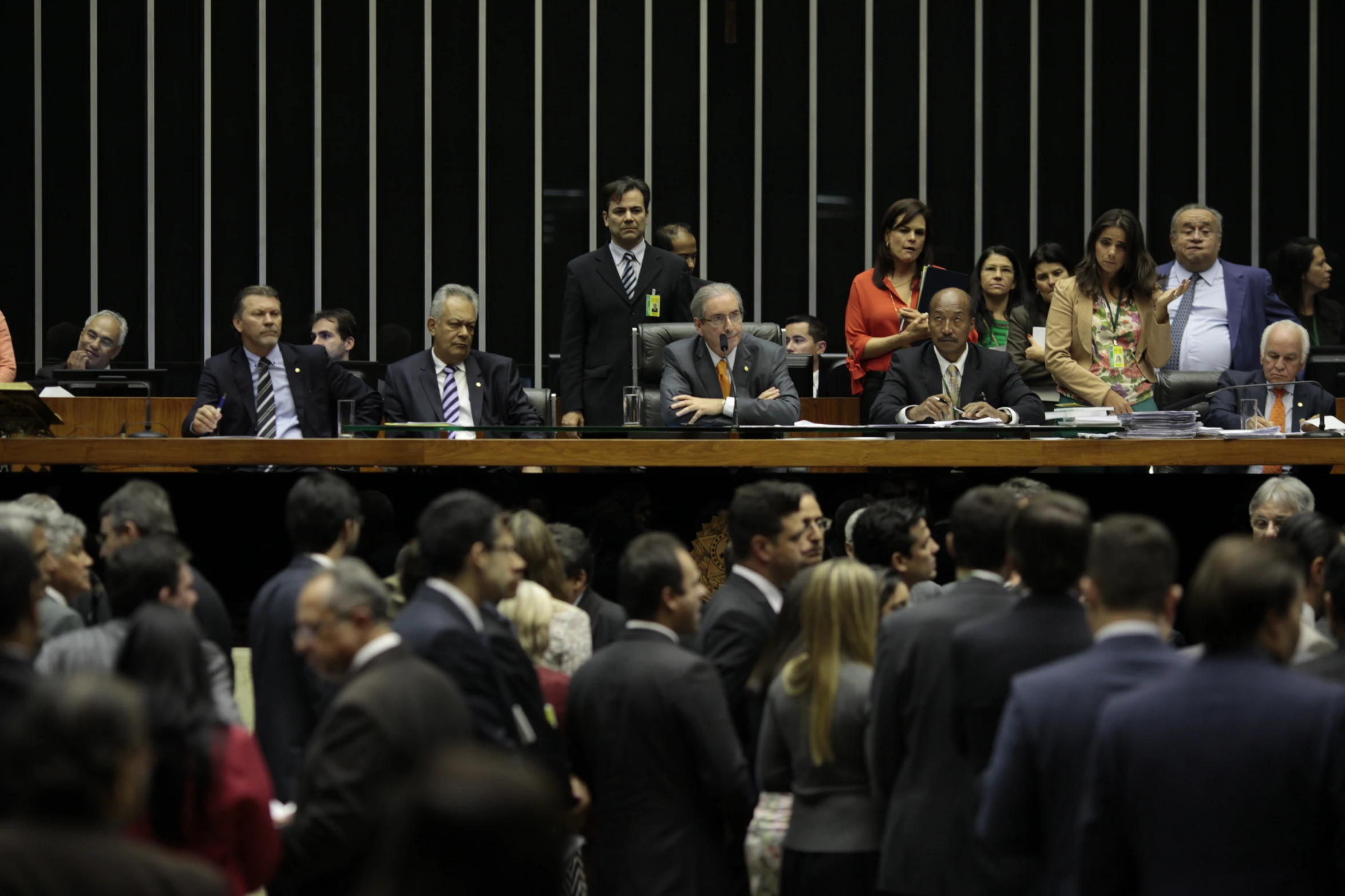 several people in suits sitting at a table