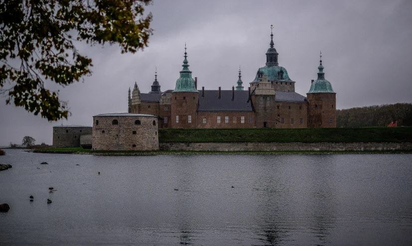 a castle that is on the side of a lake