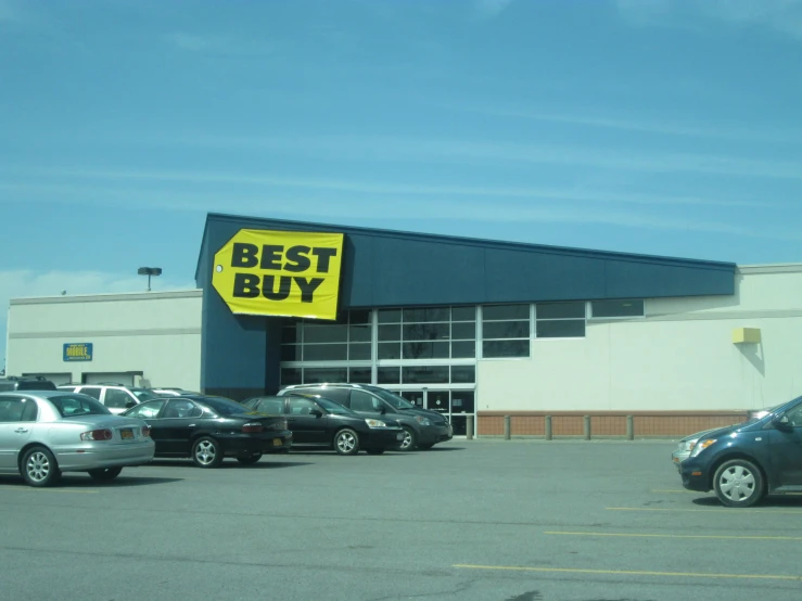 cars are parked outside a best buy store