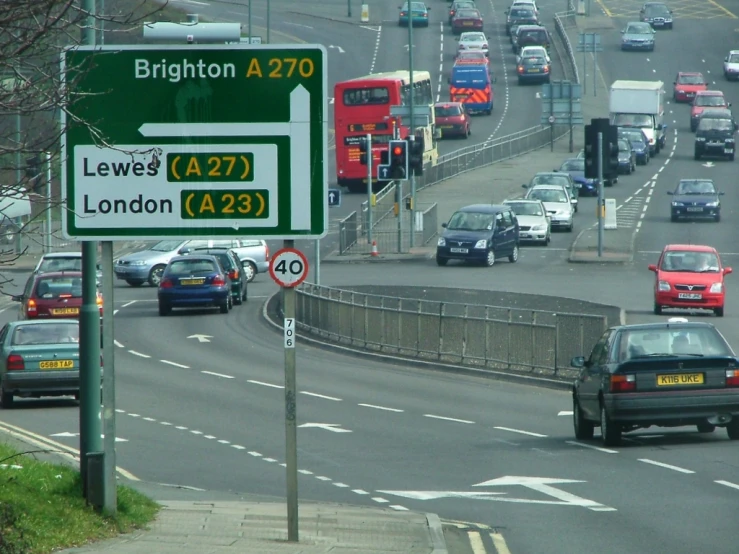 a london street with many cars, buses and buses