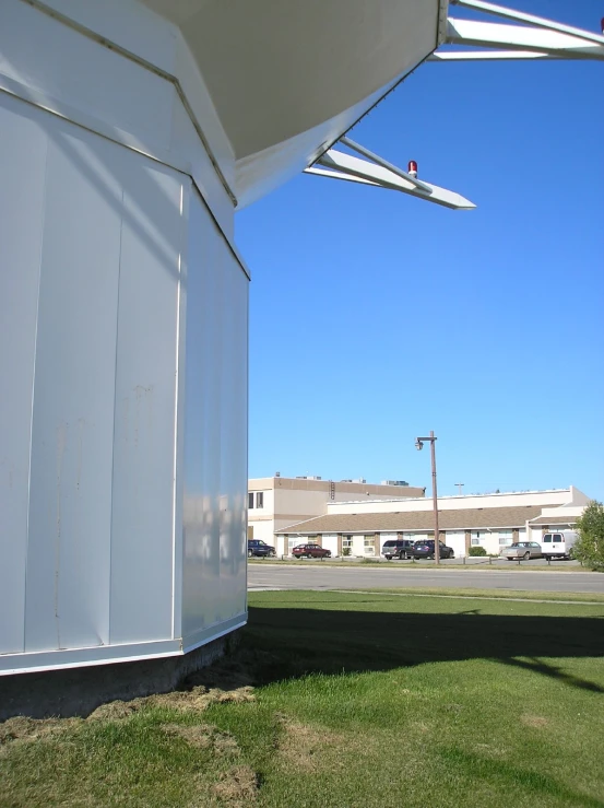 a white building with a red flag on the top of it