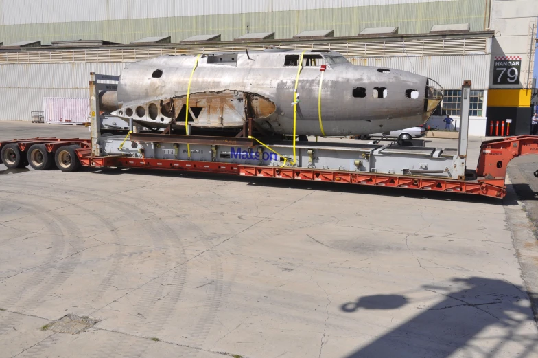 a airplane on a trailer being unloaded in an airfield