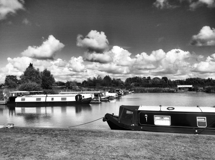 a black and white po with boats moored near shore