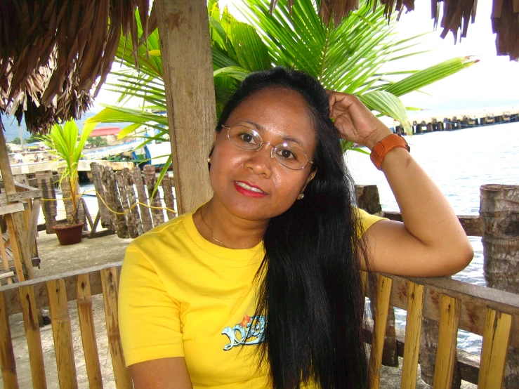 a woman in a yellow shirt has long black hair