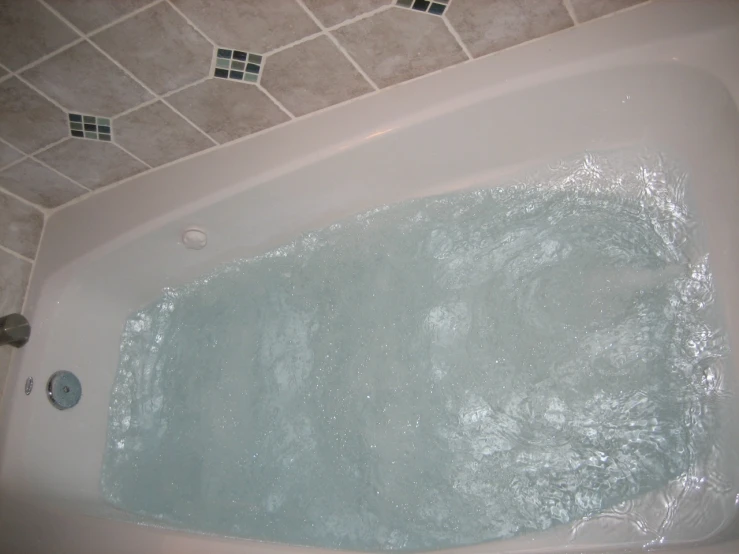 a bathtub with water running out in it