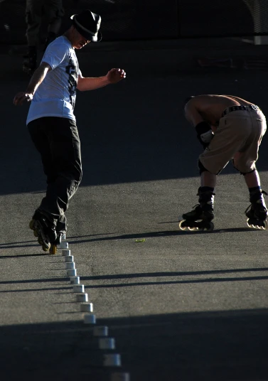 two men riding roller blades in an alley