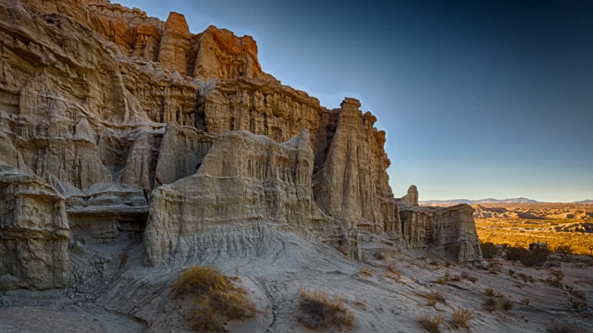 rock formation in an area with green and yellow trees