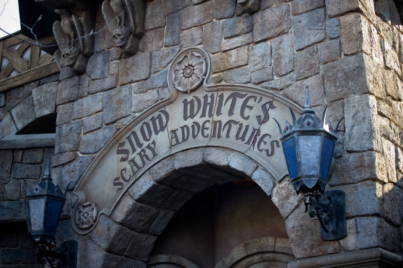 the entrance to an old school castle with signs on it