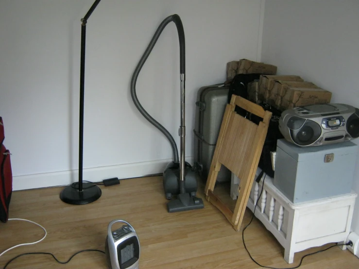 a room with two floor lamps and two different types of vacuum