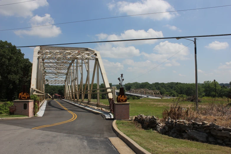 a old bridge is seen from the road