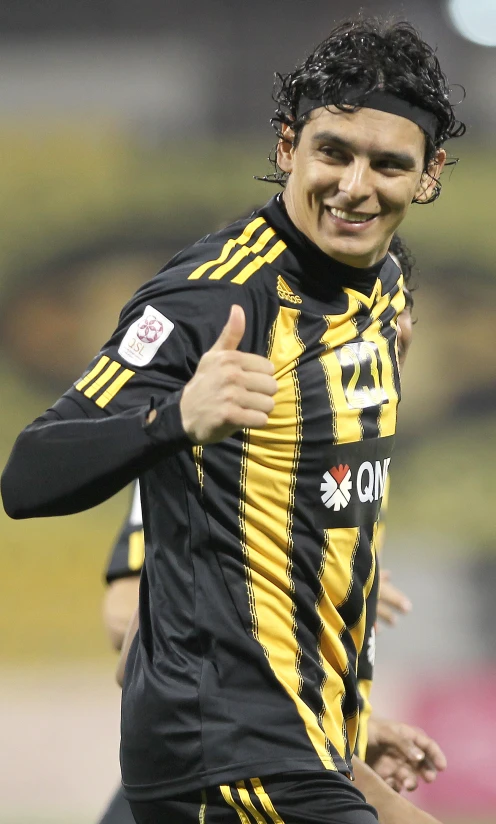 the soccer player is giving a thumbs up while making a silly face