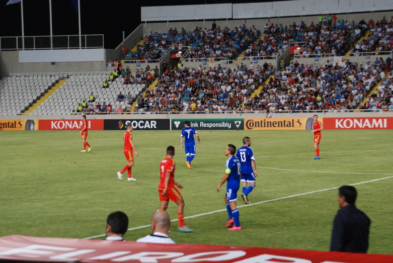 a group of men playing soccer on a field