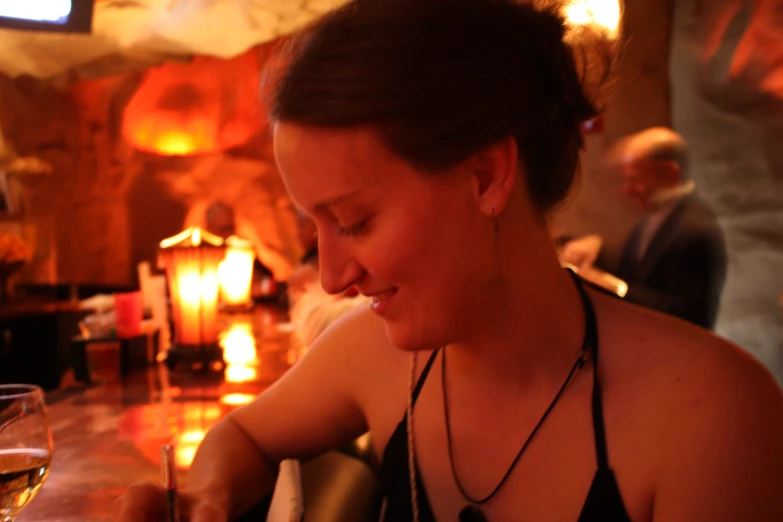 woman in front of some wine glasses drinking