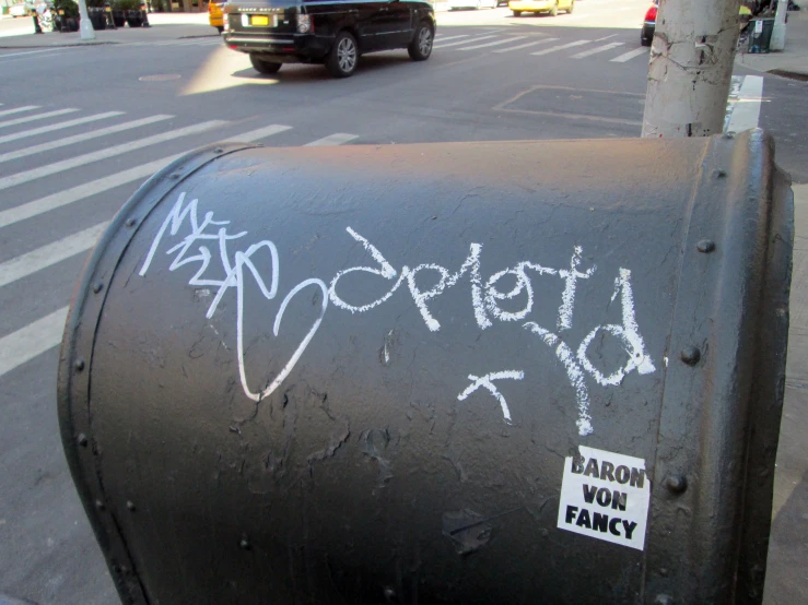 writing on a post in front of a parking meter