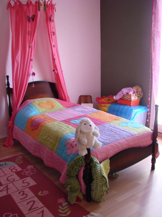 a little girl's bedroom has pink and blue accessories