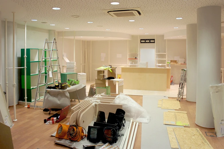 an office with white furniture and hard wood floors