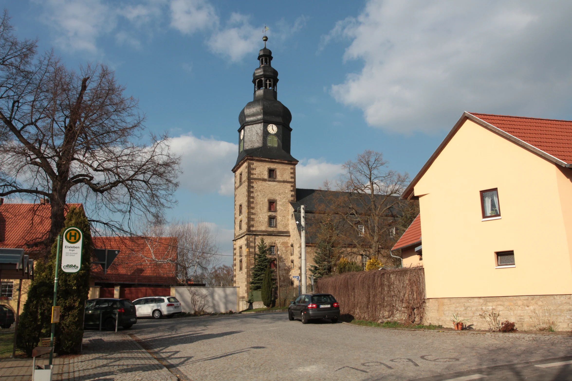 a church tower in a city on a sunny day