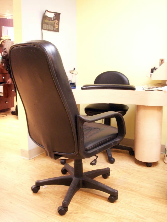 a black chair sitting on top of a wooden floor