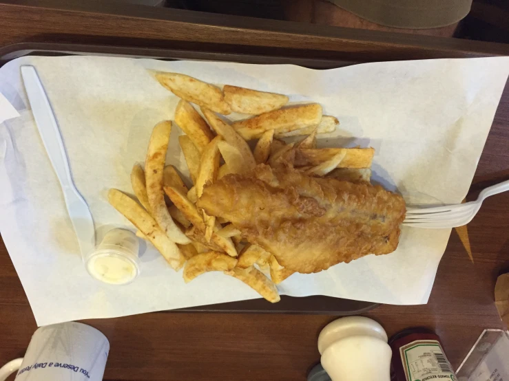 the fish and chips have been served with dressing