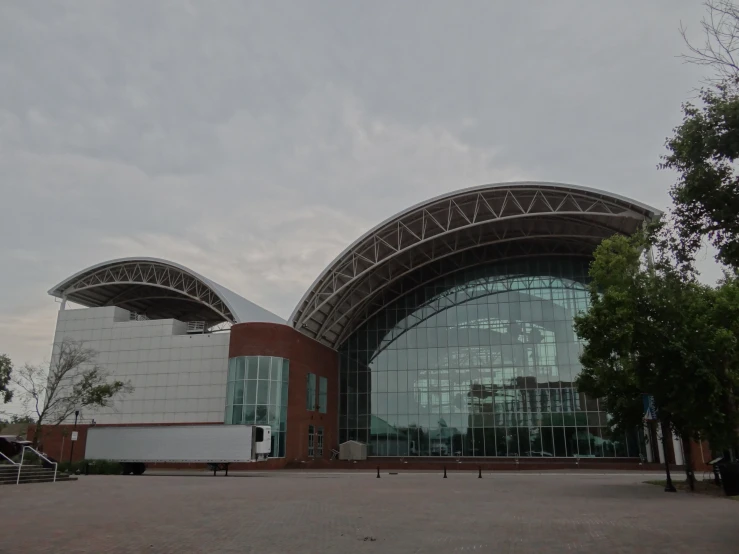 a building with two large curved windows and the roof partially covered by glass