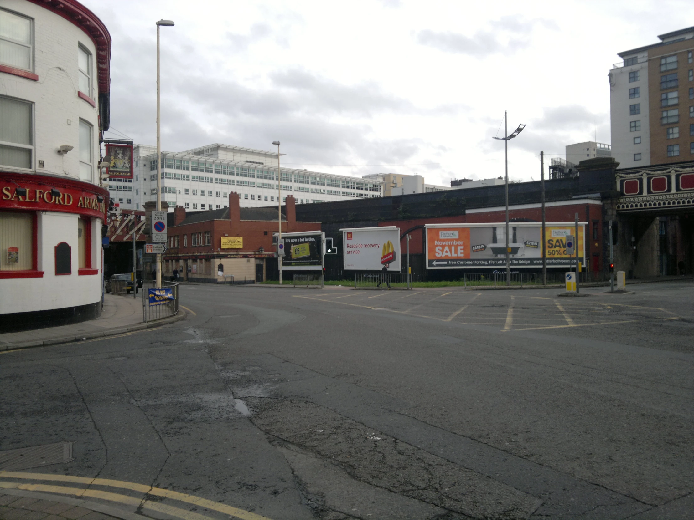 a empty road next to a set of shops