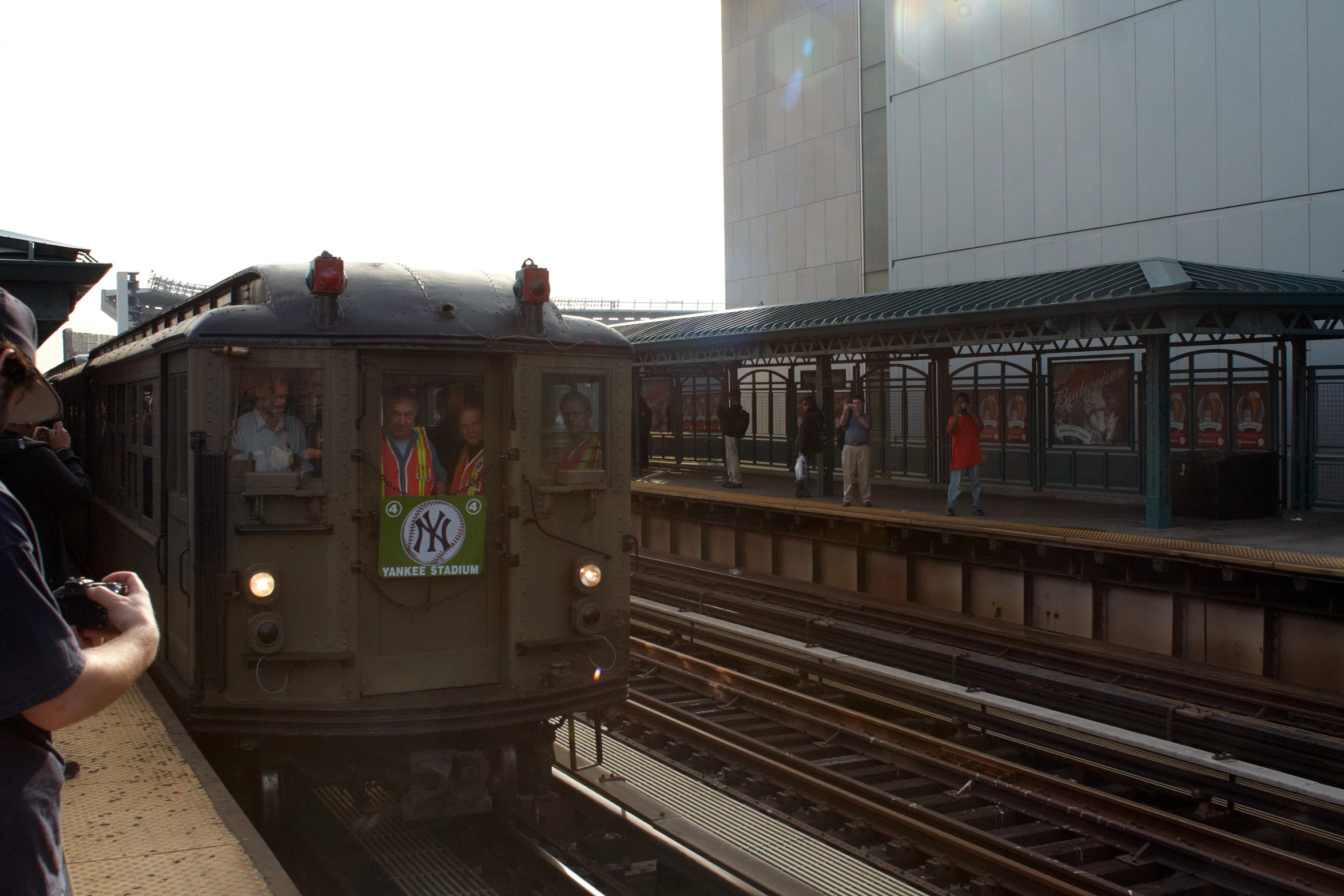 a train moving along a city street under a bridge