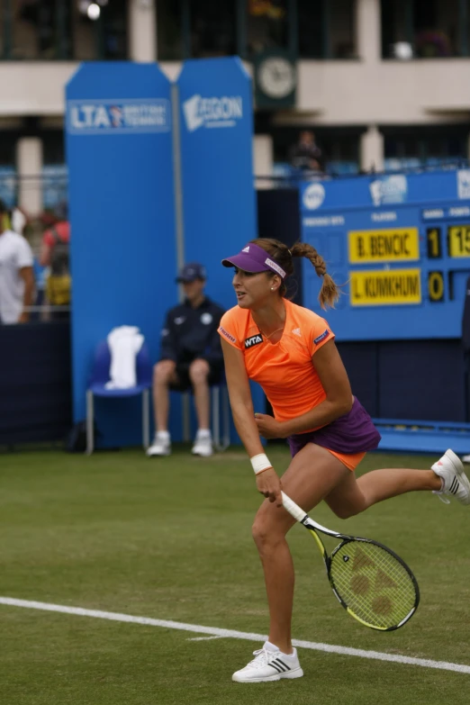 tennis player in an orange outfit during a match