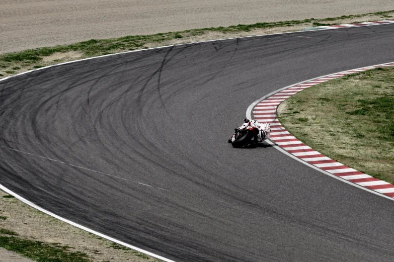 two people on motor bike racing around the track